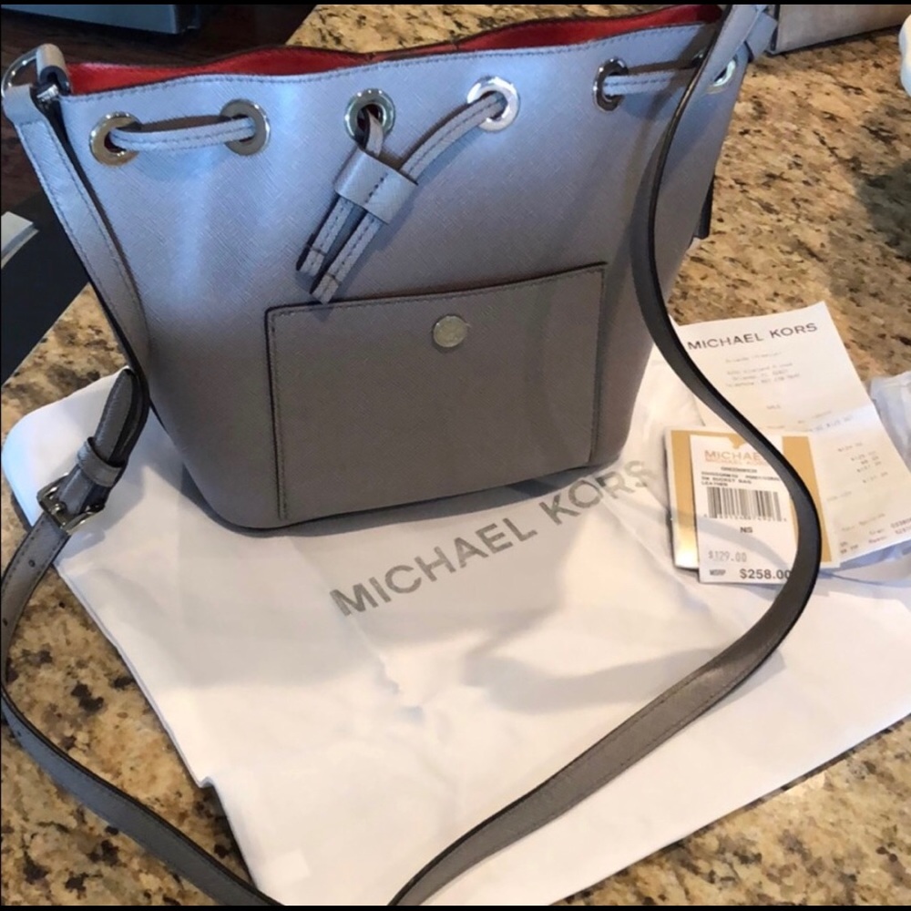 Small gray Michael Kors “bucket” crossbody bag.